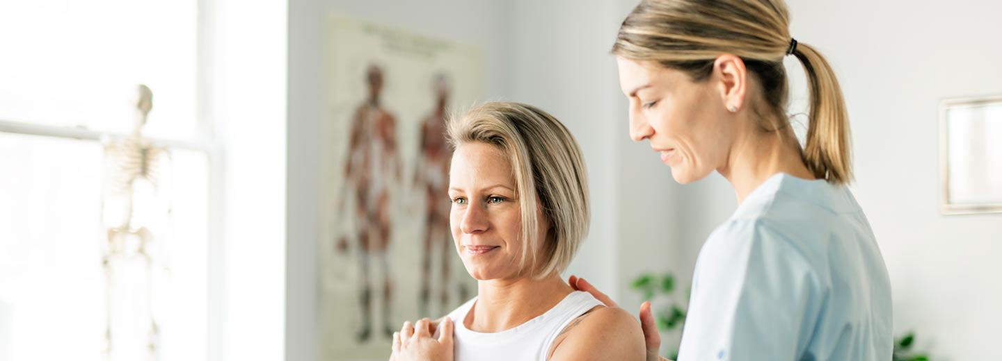 physical therapist examining patient