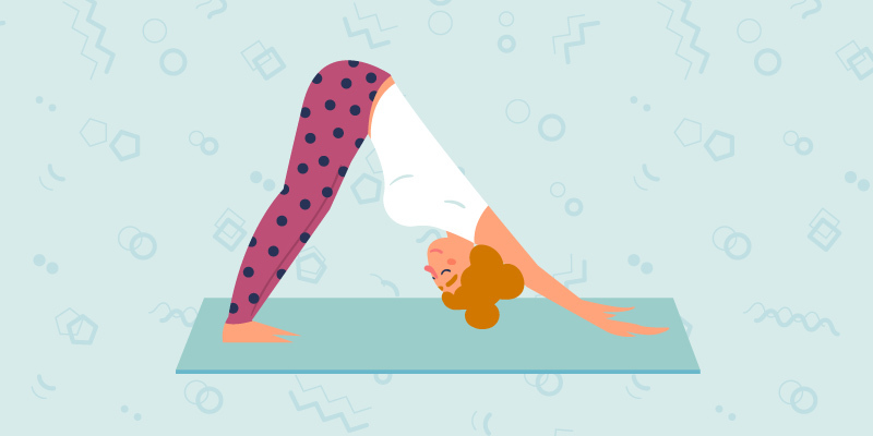 Girl doing downward dog on a yoga mat